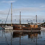 Beautiful boats on a pier with a cloudy sky in the background